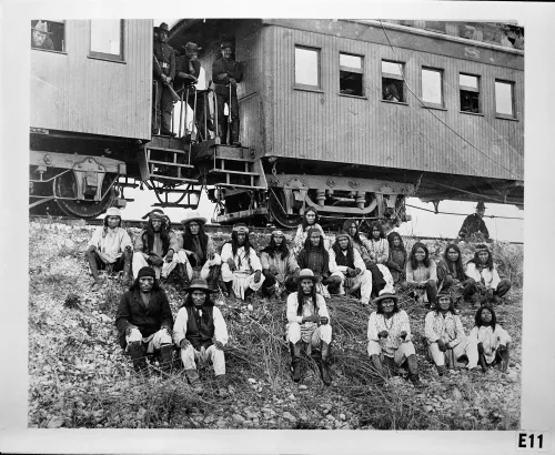 Chiricahua Apache prisoners, including Geronimo (first row, third from right), seated on an embankment outside their railroad car, Arizona #98